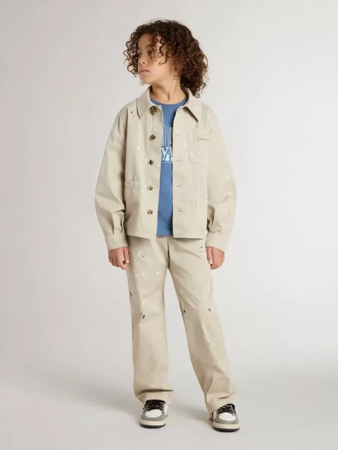 Beigefarbene Kinderjacke mit bunten Sprenkeln