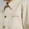 Beigefarbene Kinderjacke mit bunten Sprenkeln