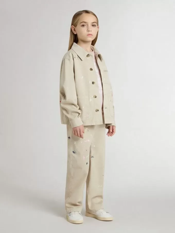 Beigefarbene Kinderjacke mit bunten Sprenkeln