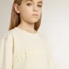 Cremefarbenes Sweatshirt für Mädchen mit Aufnäher-Schriftzug Cremefarbenes Sweatshirt für Mädchen mit Aufnäher-Schriftzug