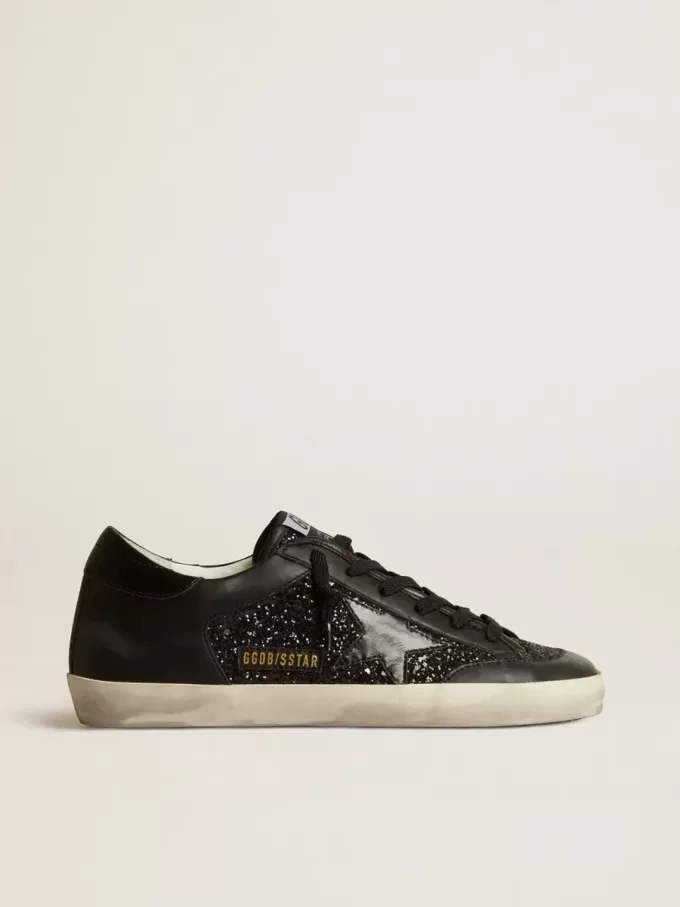 Damen-Superstar aus schwarzem Nappa und Glitzer mit glänzendem schwarzen Lederstern Damen-Superstar aus schwarzem Nappa und Glitzer mit glänzendem schwarzen Lederstern