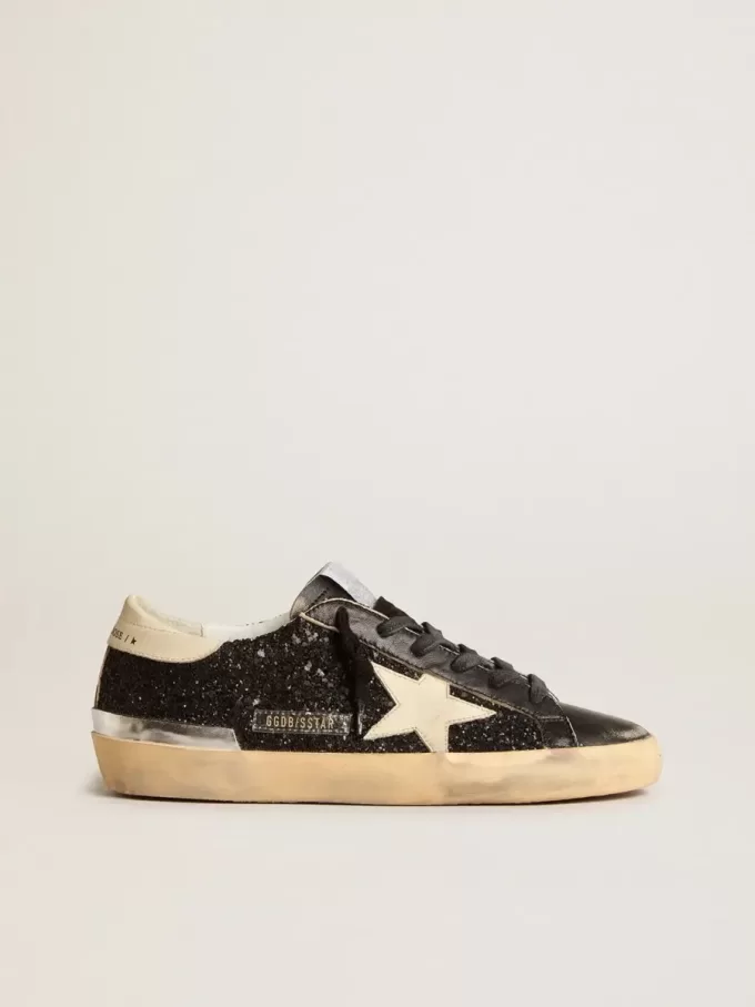 Damen-Superstar in schwarzem Glitzer und Nappa mit cremefarbenem Lederstern und Fersenlasche Damen-Superstar in schwarzem Glitzer und Nappa mit cremefarbenem Lederstern und Fersenlasche