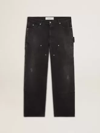 Herrenjeans aus schwarzem Baumwollstoff im Distressed-Look mit Aufnähern auf der Vorderseite