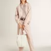 Mesh-Strickoberteil mit Pailletten und kontrastierenden Details Mesh-Strickoberteil mit Pailletten und kontrastierenden Details
