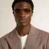 Sonnenbrille im Pilotenstil mit goldenem Rahmen und beigen Gläsern Sonnenbrille im Pilotenstil mit goldenem Rahmen und beigen Gläsern