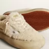 Space-Star-Damenschuhe aus beigem Lammfell mit weißem Lederstern und metallischer Lederlasche am Absatz
