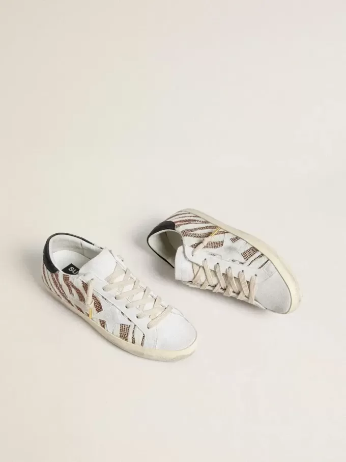 Super-Star LTD für Damen aus weißem Ponyfell mit braunem Glitzer und weißem Wildlederstern Super-Star LTD für Damen aus weißem Ponyfell mit braunem Glitzer und weißem Wildlederstern