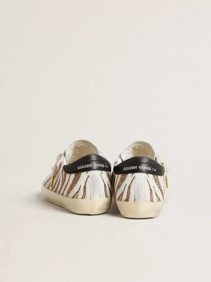 Super-Star LTD für Damen aus weißem Ponyfell mit braunem Glitzer und weißem Wildlederstern Super-Star LTD für Damen aus weißem Ponyfell mit braunem Glitzer und weißem Wildlederstern