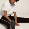 Weißes Damen-T-Shirt mit silbernem Glitzerlogo und Stern Weißes Damen-T-Shirt mit silbernem Glitzerlogo und Stern